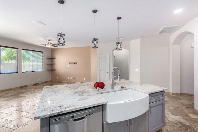 kitchen featuring dishwasher, sink, hanging light fixtures, and an island with sink