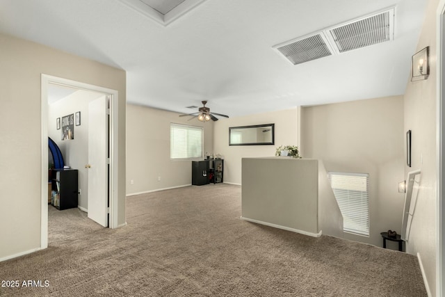 unfurnished room featuring ceiling fan and light colored carpet