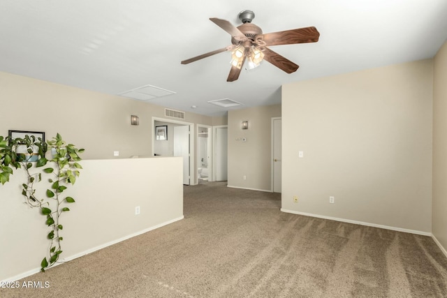 spare room featuring carpet floors and ceiling fan