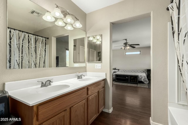 bathroom with ceiling fan, vanity, and hardwood / wood-style flooring