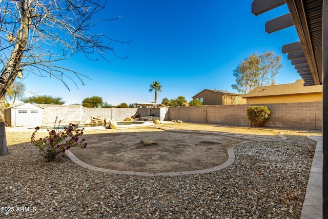 view of yard with a patio area and a storage unit