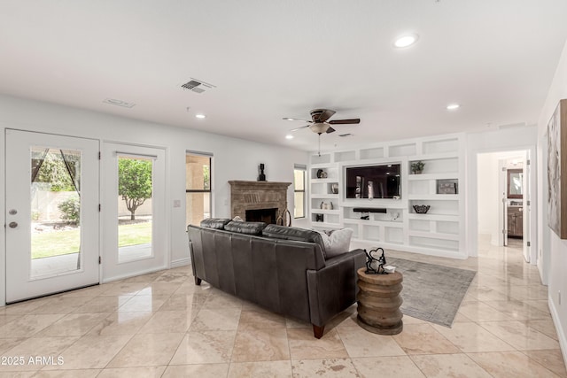 living area with recessed lighting, ceiling fan, visible vents, and a fireplace
