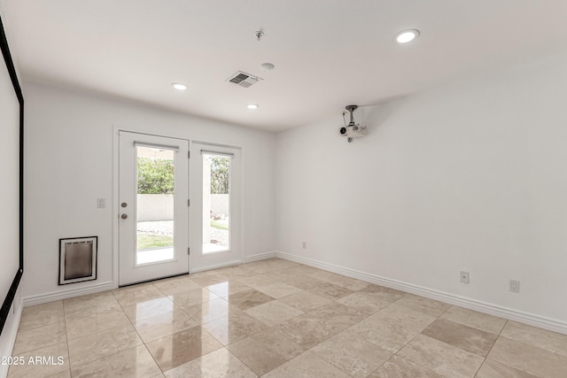 spare room featuring recessed lighting, baseboards, and visible vents