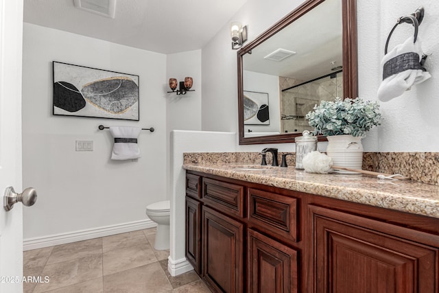 bathroom with visible vents, vanity, a shower, toilet, and baseboards