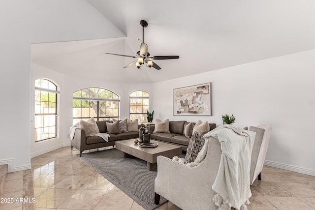 living area with a ceiling fan, baseboards, and lofted ceiling