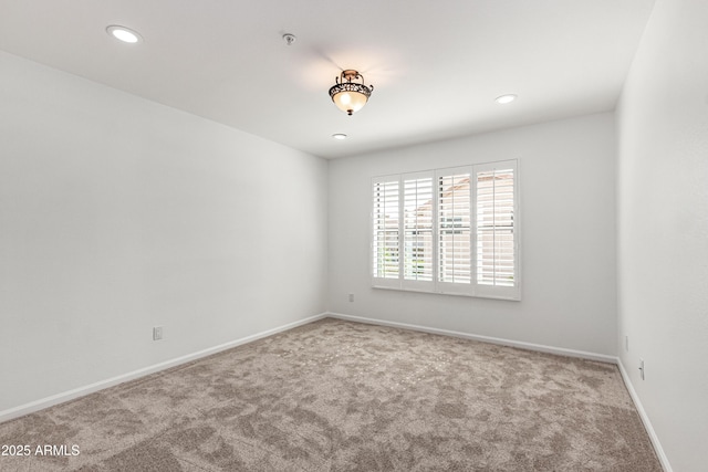 empty room with baseboards, recessed lighting, and carpet