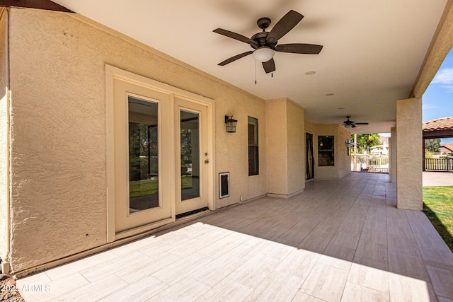 view of patio / terrace featuring ceiling fan and fence