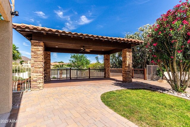 view of patio / terrace featuring fence and a ceiling fan