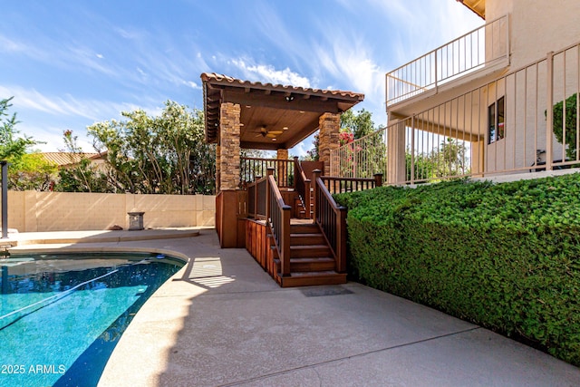 view of pool featuring a ceiling fan, fence, a fenced in pool, a patio, and stairs