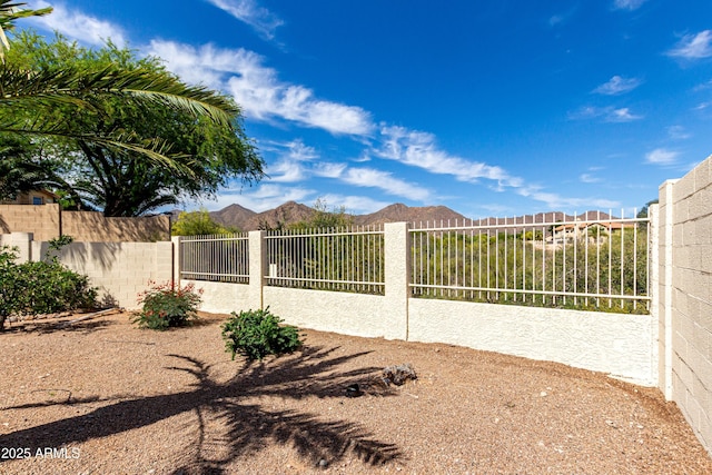 exterior space featuring fence and a mountain view