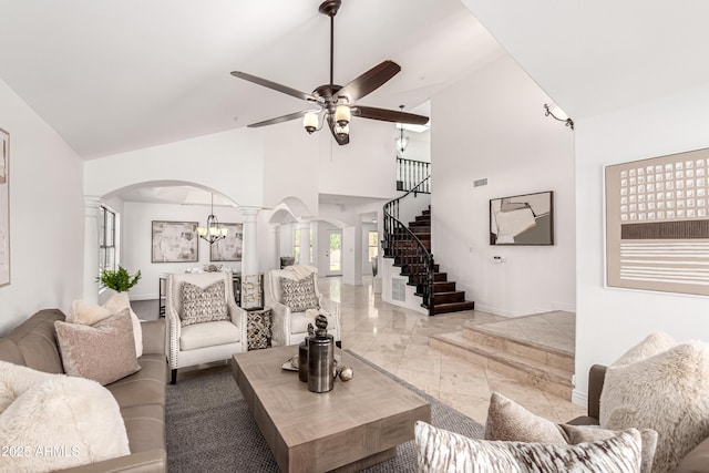 living room with decorative columns, marble finish floor, baseboards, high vaulted ceiling, and arched walkways