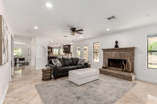 living room with baseboards, recessed lighting, and visible vents