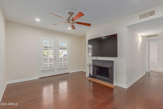 unfurnished living room with dark hardwood / wood-style floors and ceiling fan