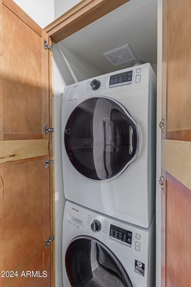 laundry room featuring stacked washer / dryer