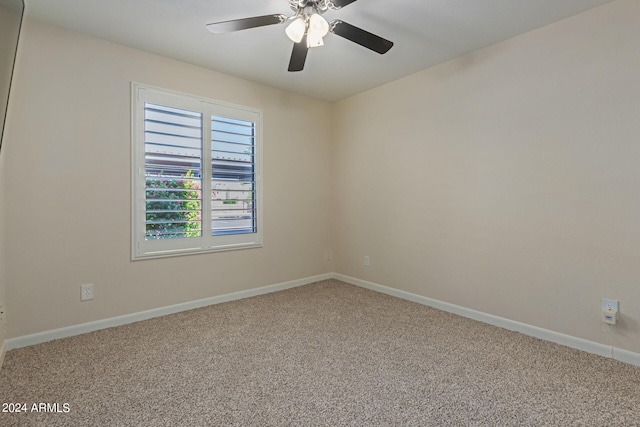 unfurnished room featuring ceiling fan and carpet floors