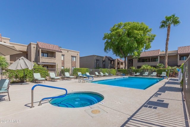 view of swimming pool featuring a patio and a community hot tub