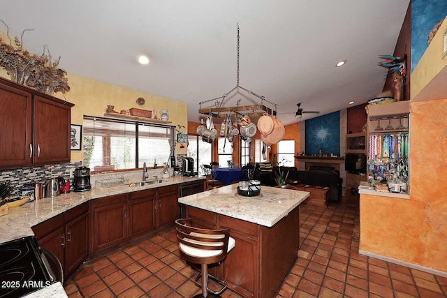 14605 S 35th Pl, Phoenix, AZ 85044 - kitchen featuring plenty of natural light, a sink, a fireplace, vaulted ceiling, and a center island