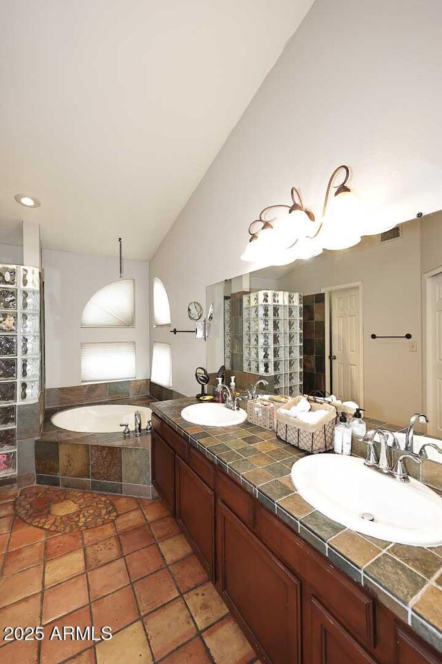 14605 S 35th Pl, Phoenix, AZ 85044 - full bathroom featuring lofted ceiling, a garden tub, double vanity, and tiled shower