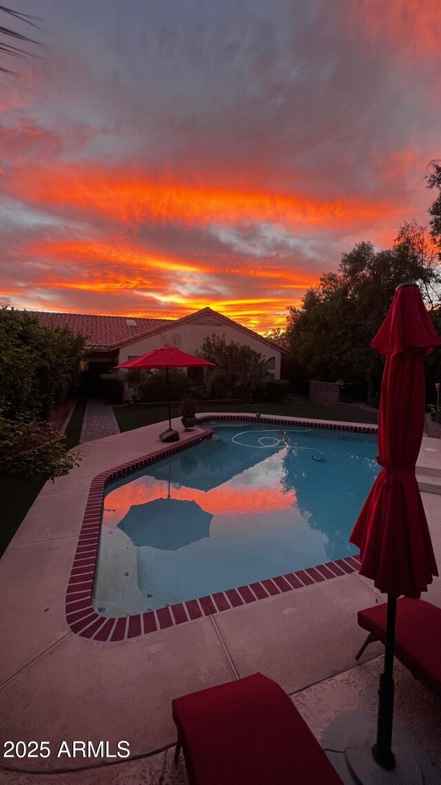 14605 S 35th Pl, Phoenix, AZ 85044 - pool at dusk featuring an outdoor pool and a patio