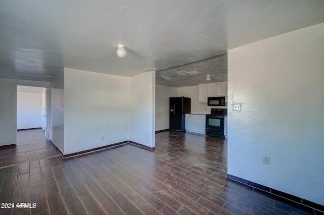 unfurnished room with dark wood-type flooring