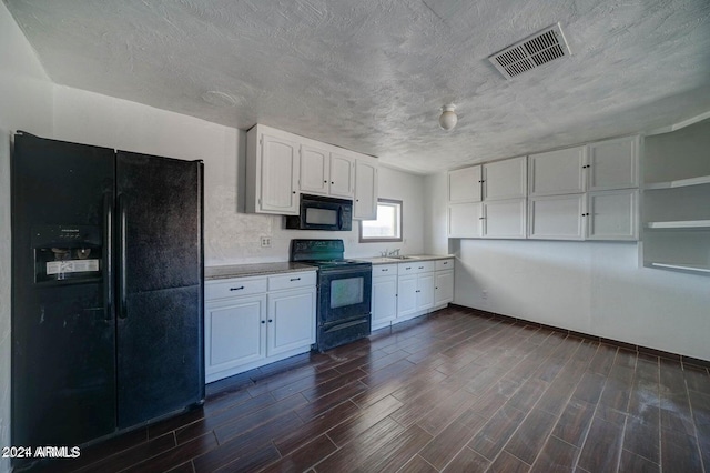 kitchen featuring a textured ceiling, sink, white cabinetry, black appliances, and dark hardwood / wood-style flooring