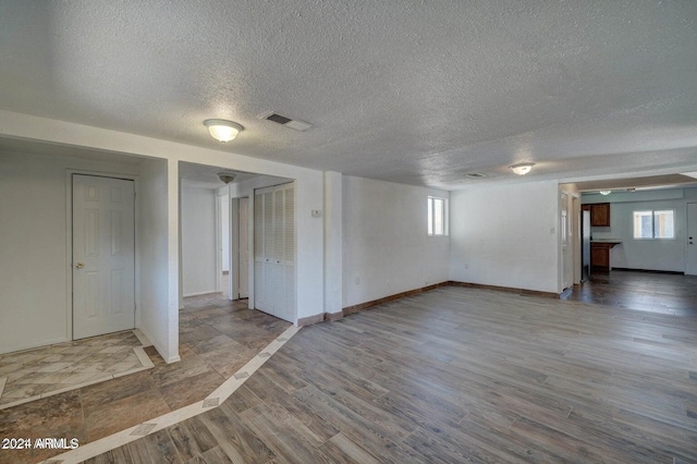 interior space featuring a textured ceiling and hardwood / wood-style flooring