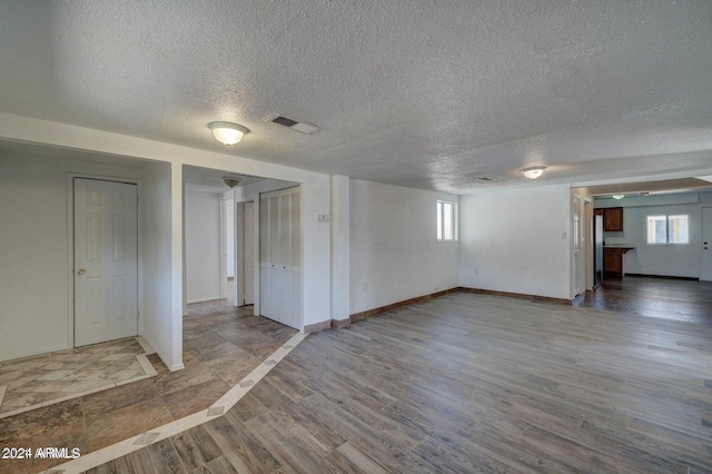 753 W Riverside St, Phoenix, AZ 85041 - basement featuring a textured ceiling, healthy amount of natural light, and wood finished floors