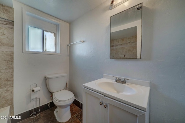 bathroom with tile patterned floors, vanity, and toilet