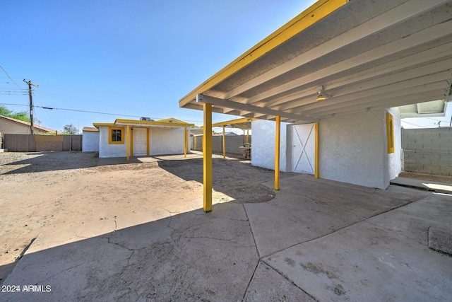 view of patio / terrace featuring a storage shed and a carport