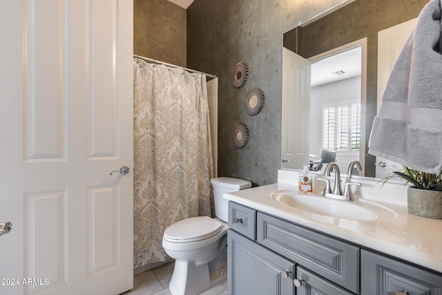 bathroom with vanity, toilet, and tile patterned floors