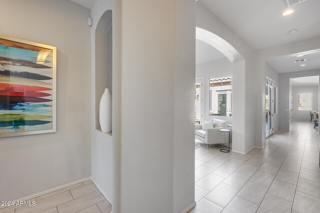 hall with light tile patterned floors