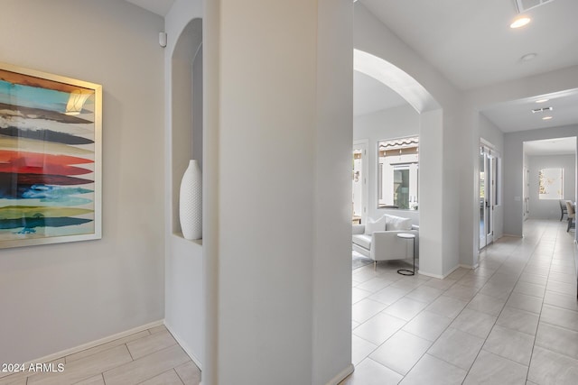 2340 W Horsetail Trl, Phoenix, AZ 85085 - corridor featuring arched walkways, baseboards, light tile patterned floors, and recessed lighting