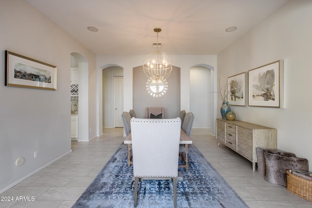 dining space with an inviting chandelier and light tile patterned floors