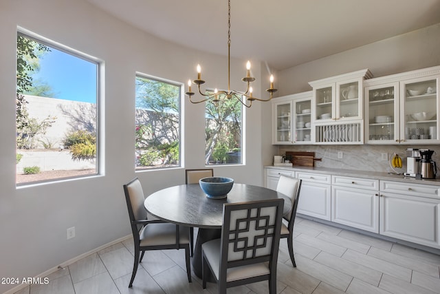 dining area with an inviting chandelier