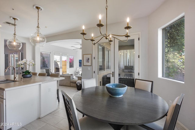 2340 W Horsetail Trl, Phoenix, AZ 85085 - dining room with ceiling fan, light tile patterned floors, a chandelier, and arched walkways
