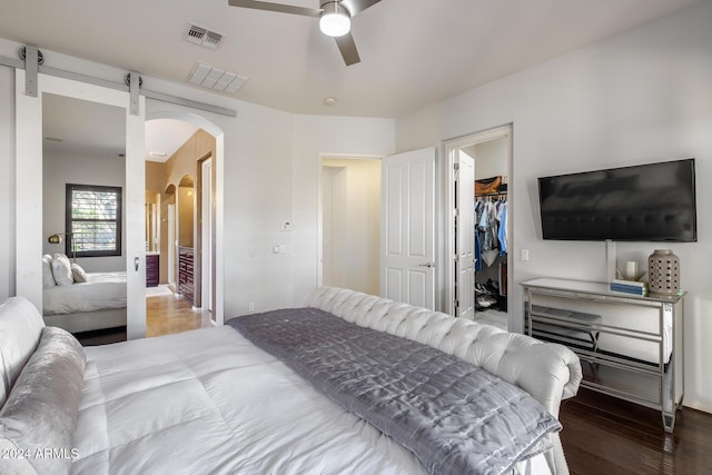 2340 W Horsetail Trl, Phoenix, AZ 85085 - bedroom with arched walkways, wood finished floors, a spacious closet, ceiling fan, and a closet