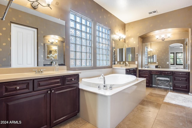 2340 W Horsetail Trl, Phoenix, AZ 85085 - bathroom with wallpapered walls, a garden tub, tile patterned floors, and two vanities