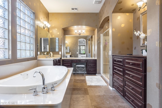 bathroom featuring vanity, separate shower and tub, and plenty of natural light