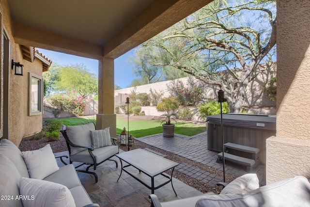 view of patio / terrace with a hot tub and an outdoor hangout area