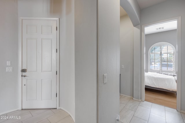 corridor with light tile patterned floors