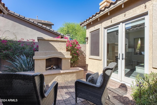 2340 W Horsetail Trl, Phoenix, AZ 85085 - view of patio with exterior fireplace and french doors