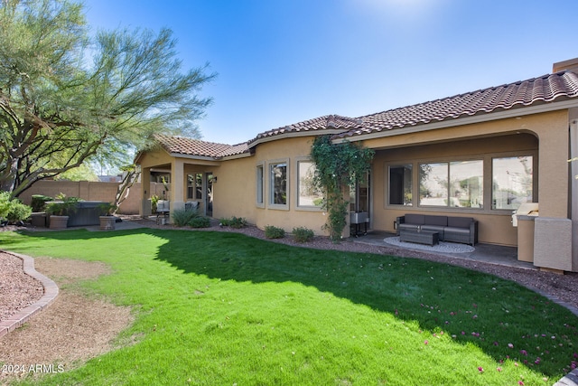 back of property featuring a patio area, an outdoor hangout area, and a lawn