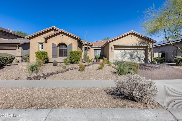 2340 W Horsetail Trl, Phoenix, AZ 85085 - view of front of home with stucco siding, an attached garage, a tile roof, and decorative driveway