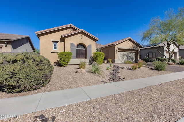 2340 W Horsetail Trl, Phoenix, AZ 85085 - mediterranean / spanish-style house featuring a tile roof, stucco siding, and a garage