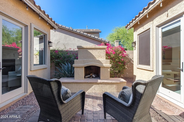 2340 W Horsetail Trl, Phoenix, AZ 85085 - view of patio / terrace with an outdoor fireplace