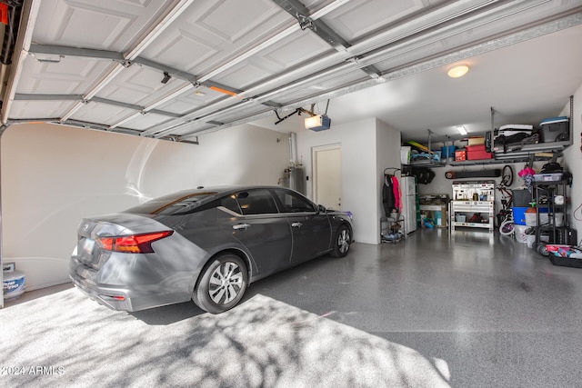 garage featuring a garage door opener and electric water heater