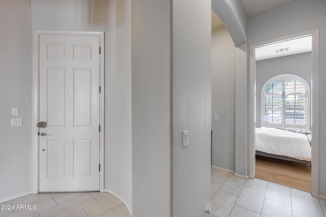 2340 W Horsetail Trl, Phoenix, AZ 85085 - hall with arched walkways, baseboards, and light tile patterned floors