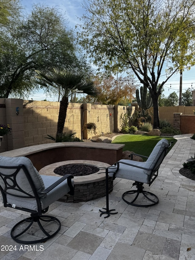 view of patio with a fire pit