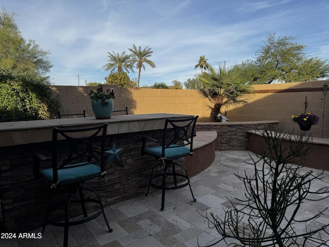 view of patio featuring an outdoor bar