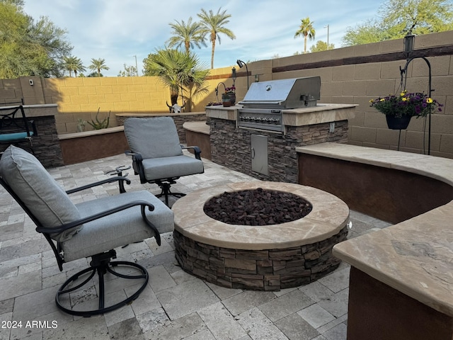 view of patio / terrace with an outdoor kitchen, area for grilling, and an outdoor fire pit